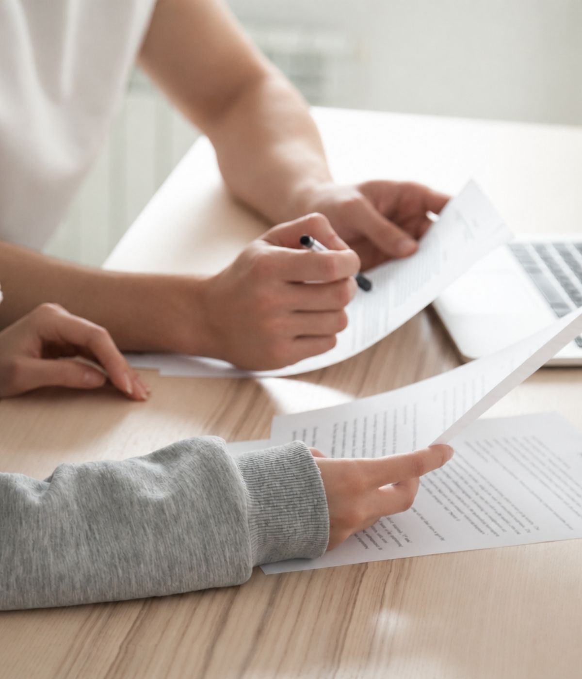 Two people reviewing and signing a cash offer contract at a table — what to know before you sign